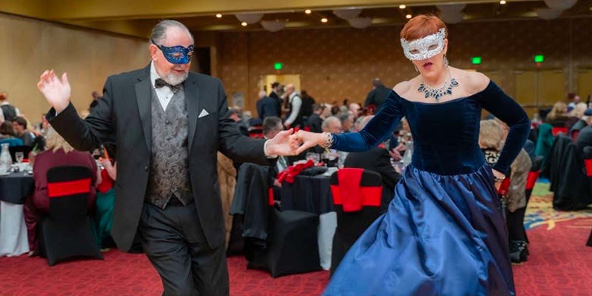 Header for Jay Billups Creative Media event photography featuring mask dancers enjoying live music