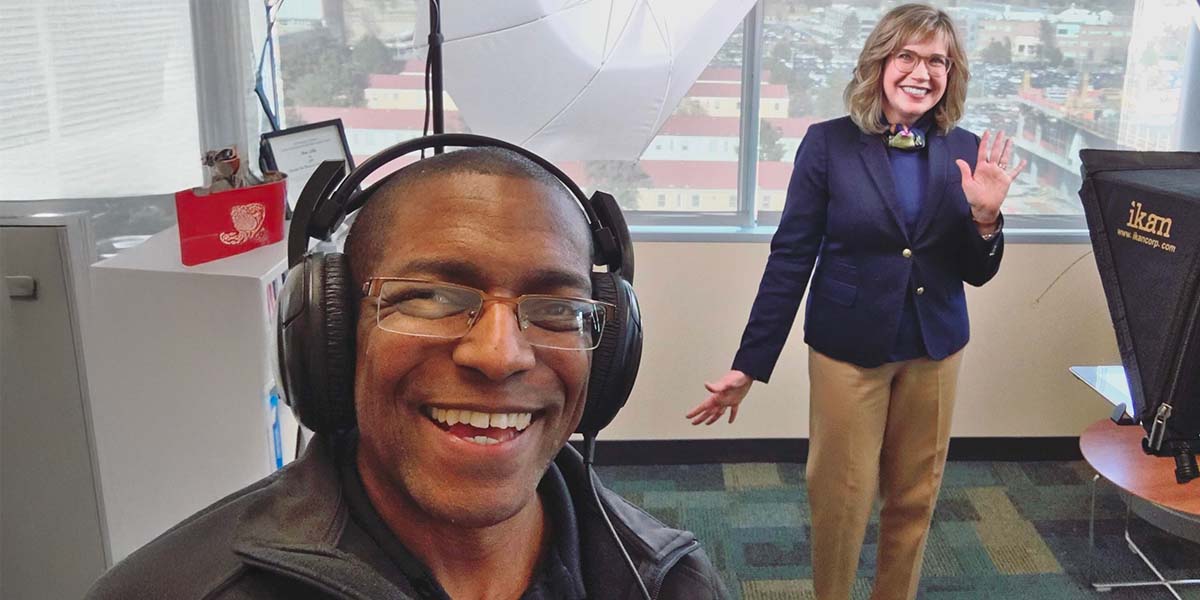 Behind-the-scenes photo of Jay Billups filming a course intro video with teleprompter filming setup at Anschutz Medical campus in Denver