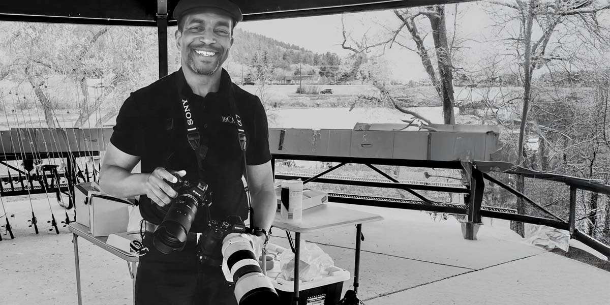 Behind-the-scenes photo of Jay Billups photographing a fishing derby event a with multiple Sony cameras in Palmer Park Colorado